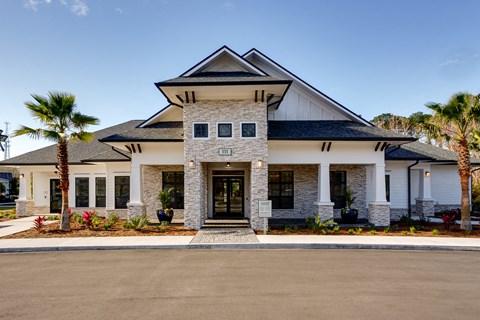 a large house with palm trees in front of it