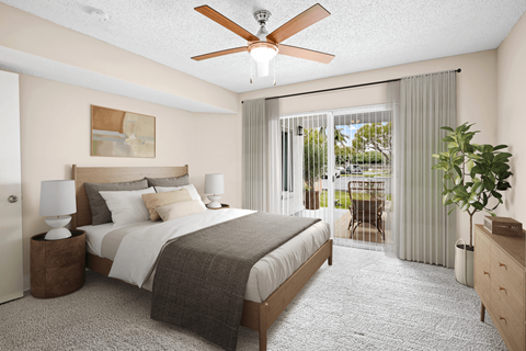 a bedroom with a bed and a ceiling fan