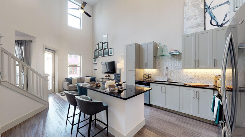 Interior of two bedroom model facing the kitchen and staircase to the second floor