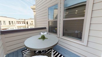 Exterior patio of apartment with small bistro table and chairs on outdoor rug - Photo Gallery 118