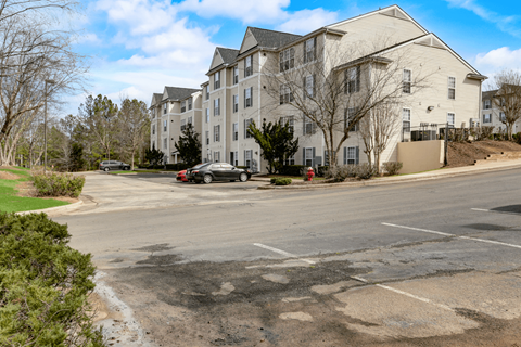 an empty parking lot in front of an apartment building