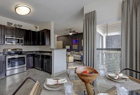 an open kitchen and dining room with a table and chairs