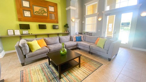 A living room with a grey couch and a coffee table.