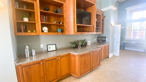 A kitchen with wooden cabinets and a granite countertop.