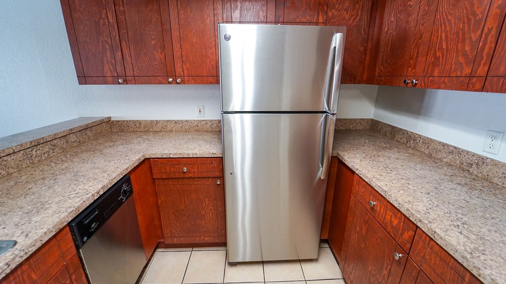 Kitchen with Breakfast Bar, Wood Cabinets, Tan Counters and Stainless Steel Appliances
