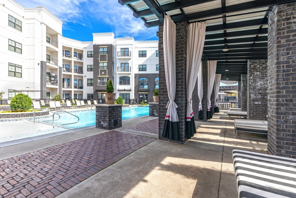 A pool area with lounge chairs.