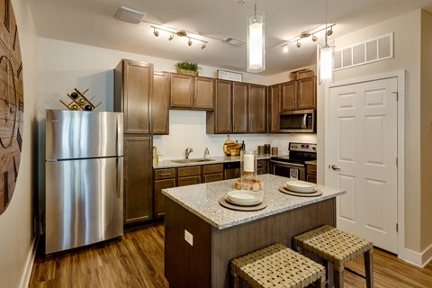 a kitchen with stainless steel appliances and a granite counter top