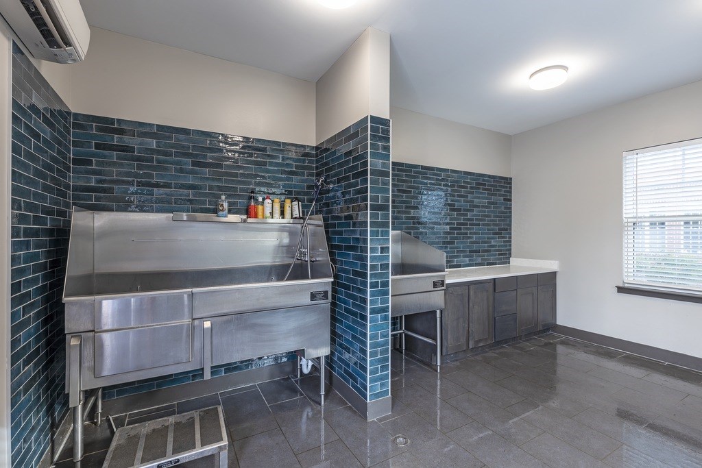 A kitchen with a stainless steel sink and counter.