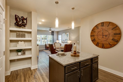 a living room and dining room with a large clock on the wall