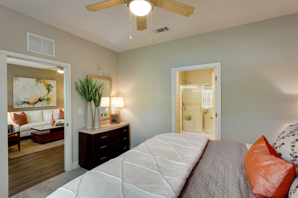 a bedroom with a large bed and a ceiling fan
