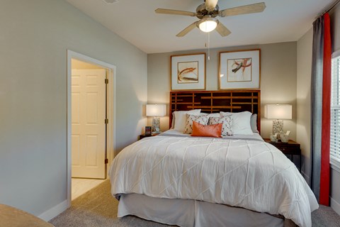 a bedroom with a large bed and a ceiling fan
