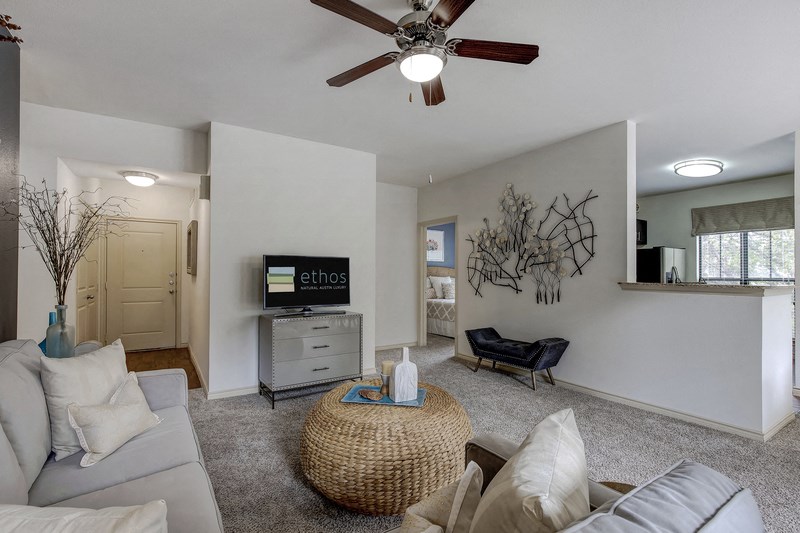 a living room with a ceiling fan and a couch