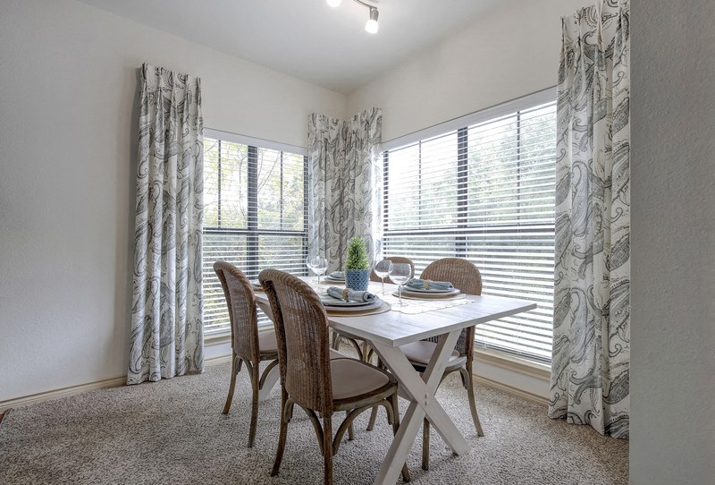an image of a dining room with a table and chairs