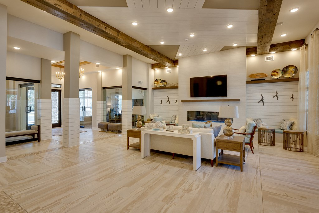a living room with a fireplace and a table and chairs