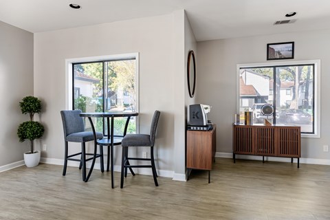 A dining room with a table and chairs.