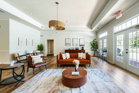 A living room with a brown coffee table and a red couch.