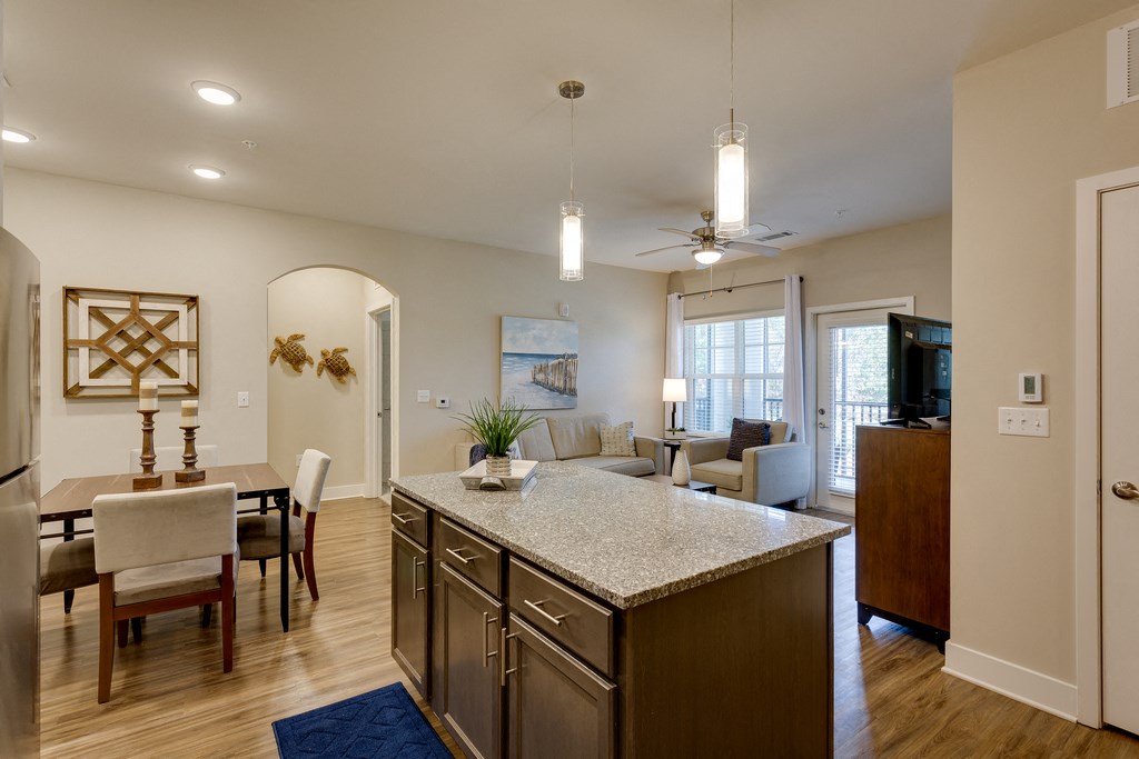 an open kitchen and living room with a dining room table and chairs