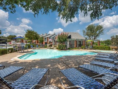 Swimming pool with lounge chairs alongside the pool.