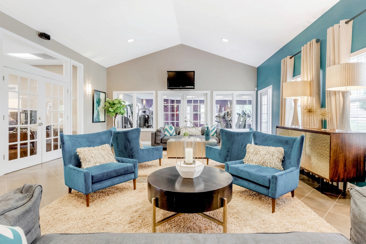 A living room with blue chairs and a coffee table.
