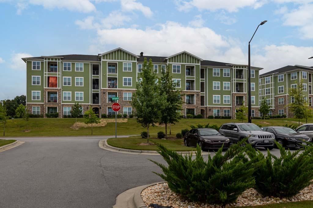 A large apartment complex with a parking lot in front at Foxwood Apartments, Raleigh-Durham, North Carolina