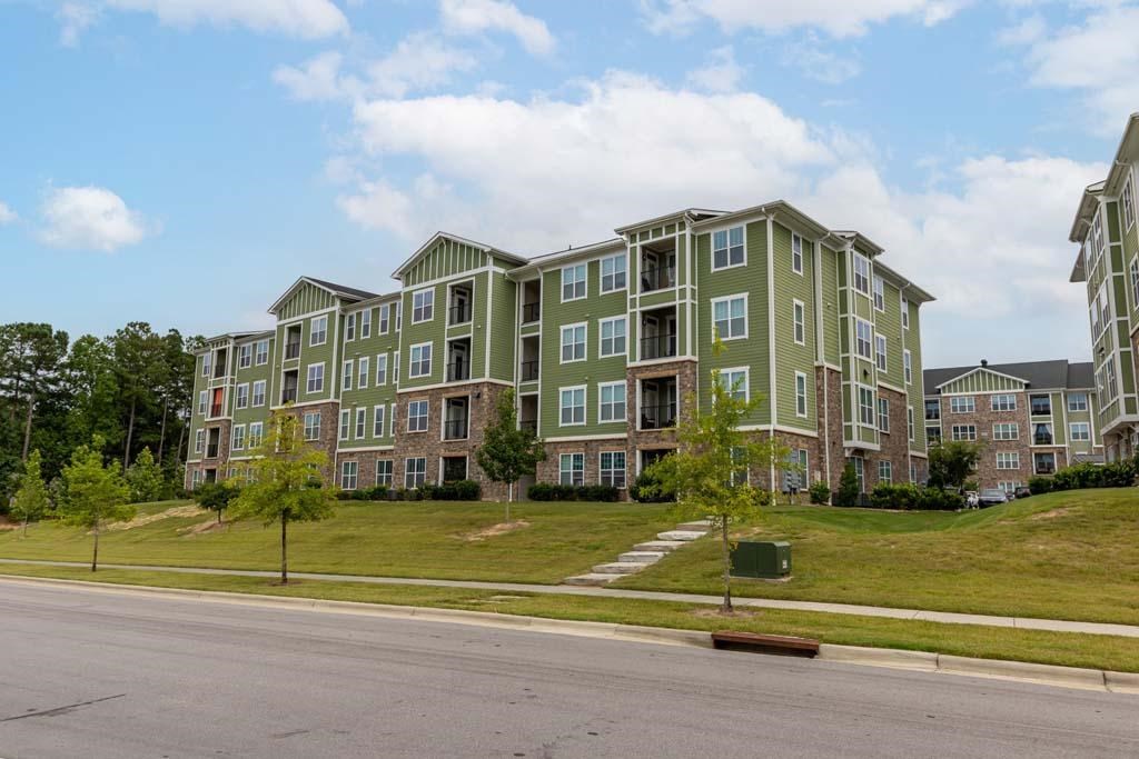 A large apartment complex with multiple buildings and green lawns at Foxwood Apartments, Raleigh-Durham, NC, 27616