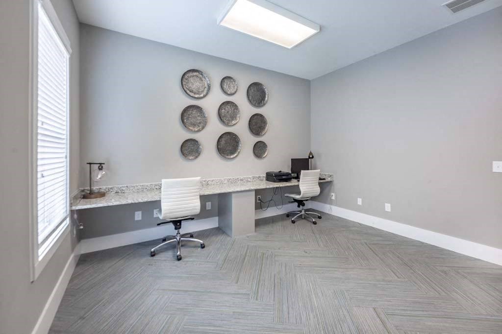 A room with a desk, chairs, and a wall decoration at Foxwood Apartments, Raleigh-Durham, 27616
