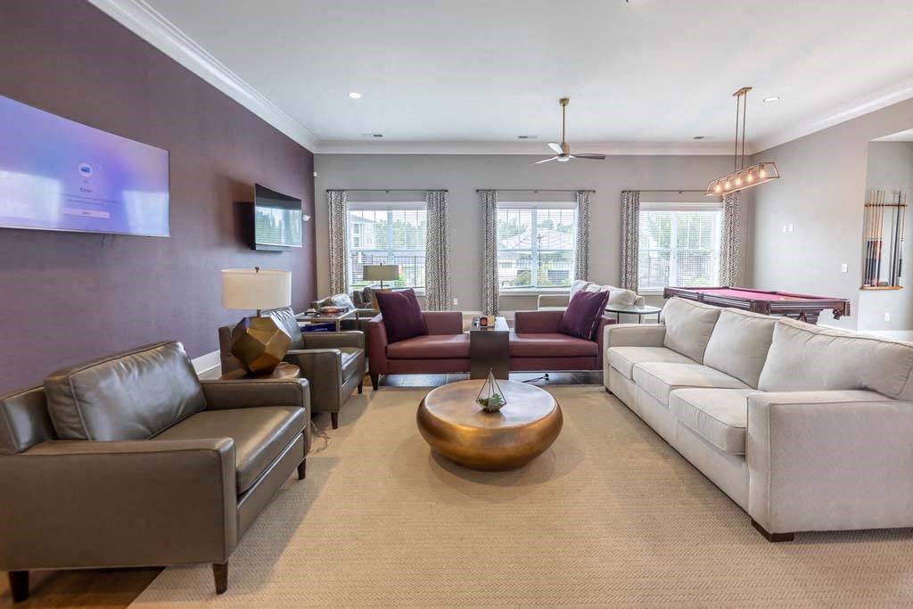 A living room with a white couch and a wooden coffee table at Foxwood Apartments, North Carolina