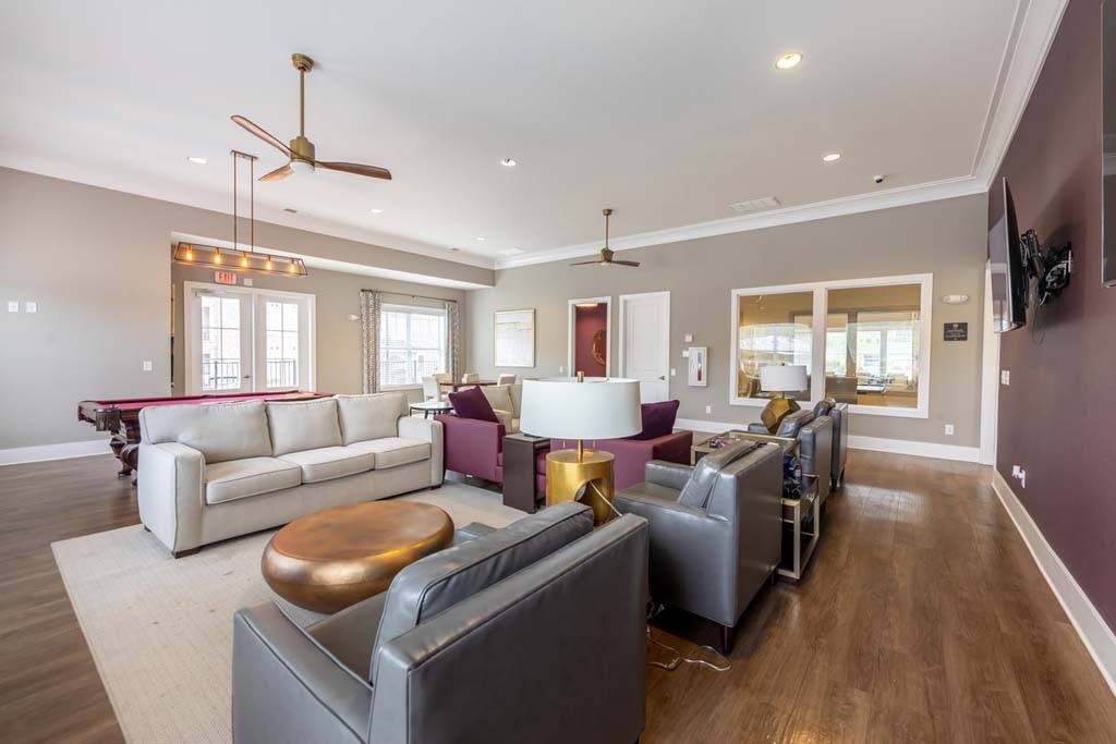 A living room with a white couch and a wooden coffee table at Foxwood Apartments, North Carolina
