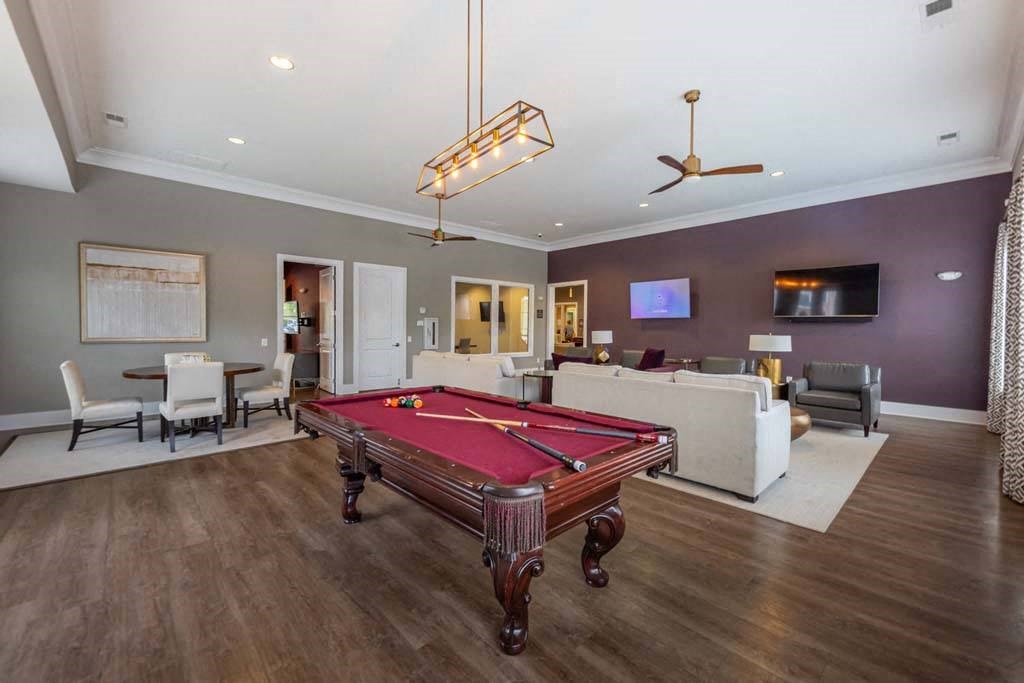 A room with a pool table and a television at Foxwood Apartments, Raleigh-Durham