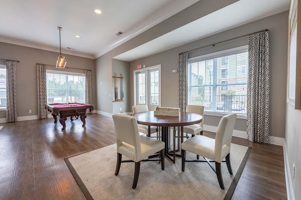 A dining room with a table set for four at Foxwood Apartments, North Carolina, 27616