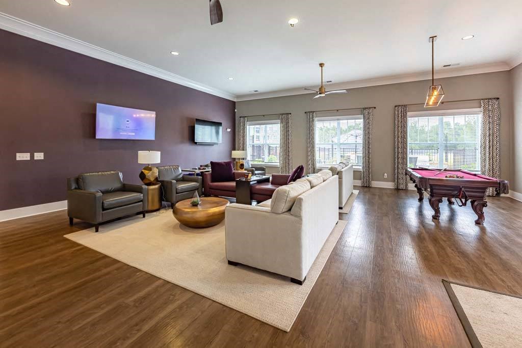A living room with a white couch and a wooden floor at Foxwood Apartments, North Carolina, 27616