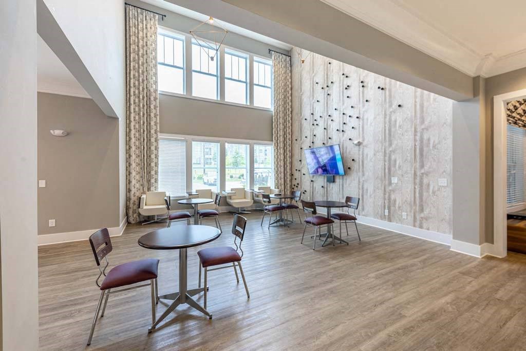 A room with a table and chairs in front of a large window at Foxwood Apartments, Raleigh-Durham, NC, 27616