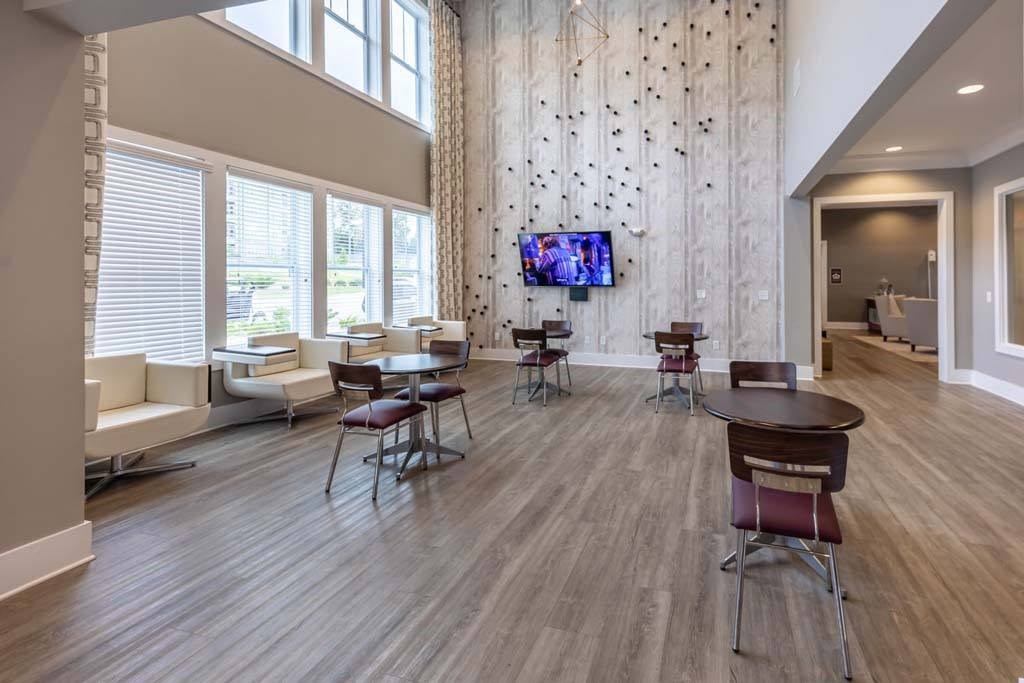 A modern living room with a television and a dining table at Foxwood Apartments, North Carolina