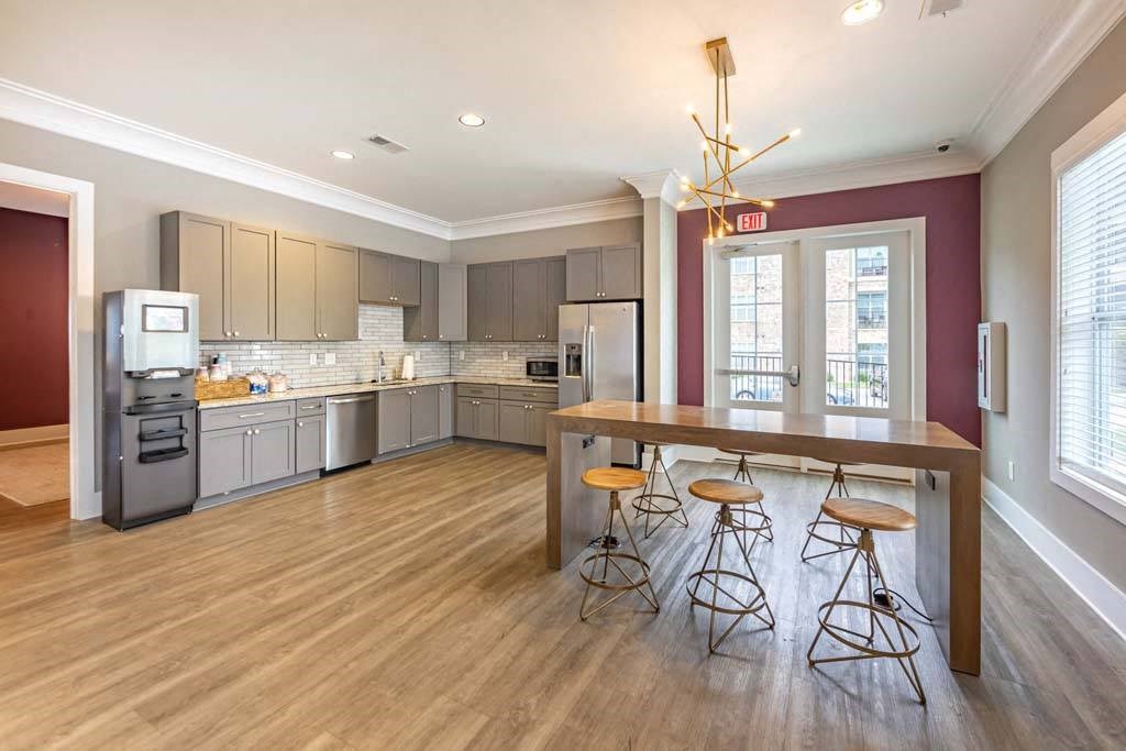 A kitchen with a bar stool and a bar table at Foxwood Apartments, Raleigh-Durham, North Carolina
