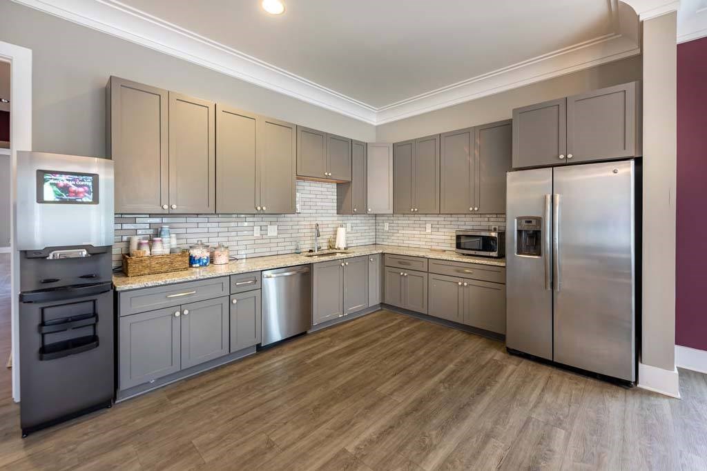 A kitchen with wooden floors and stainless steel appliances at Foxwood Apartments, Raleigh-Durham, NC