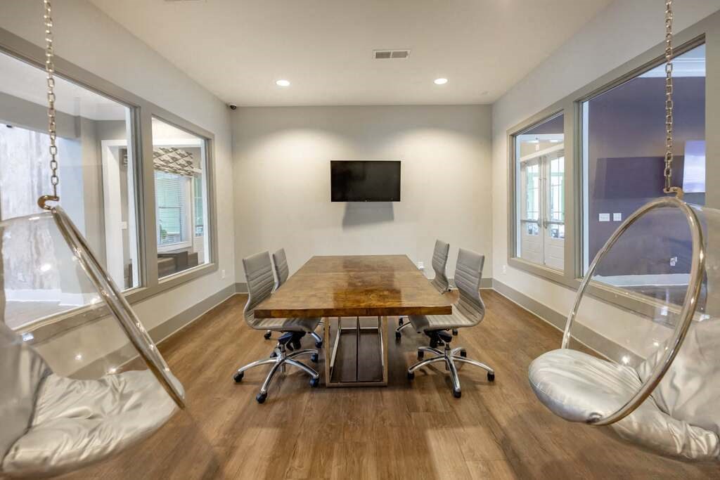A conference room with a wooden table and chairs at Foxwood Apartments, Raleigh-Durham