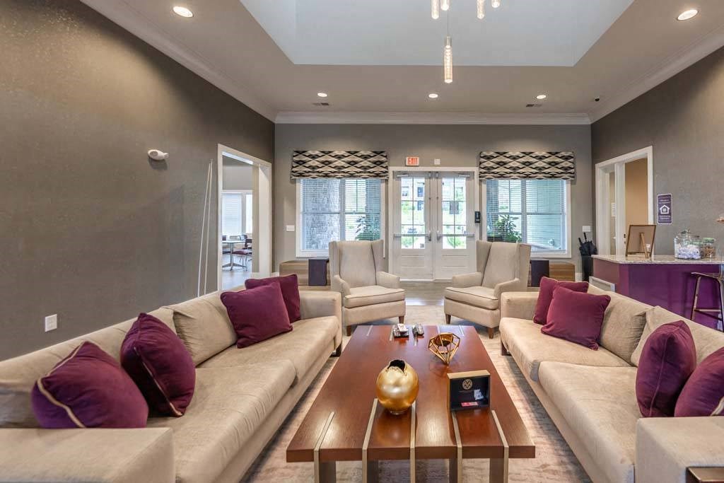 A living room with a large couch and a coffee table at Foxwood Apartments, North Carolina