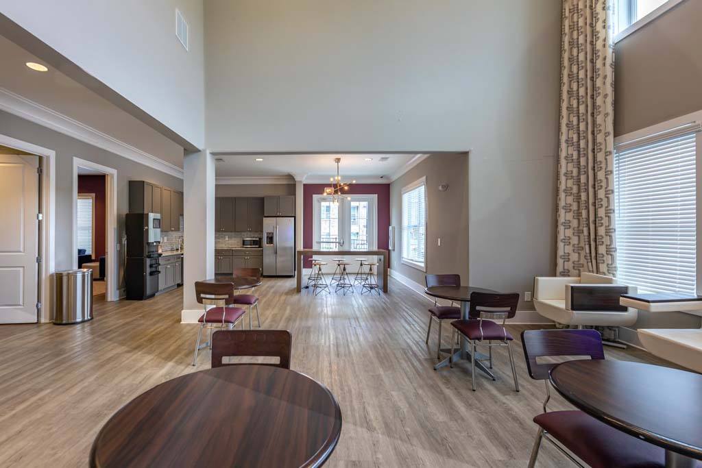 A large open living room with a dining table and chairs.