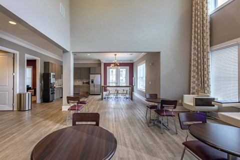 A large open living room with a dining table and chairs.