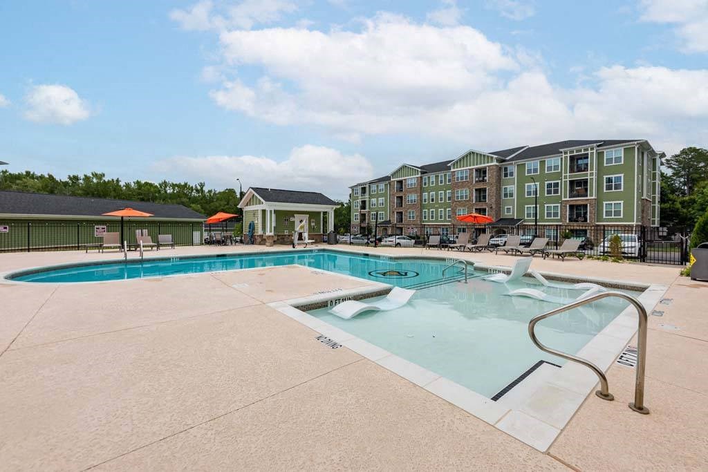 A large swimming pool with a slide in front of a building at Foxwood Apartments, Raleigh-Durham, North Carolina