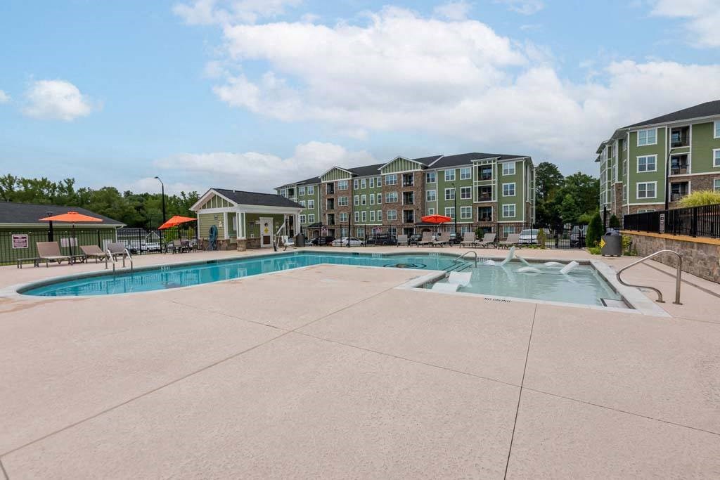 A large swimming pool surrounded by apartment buildings at Foxwood Apartments, Raleigh-Durham