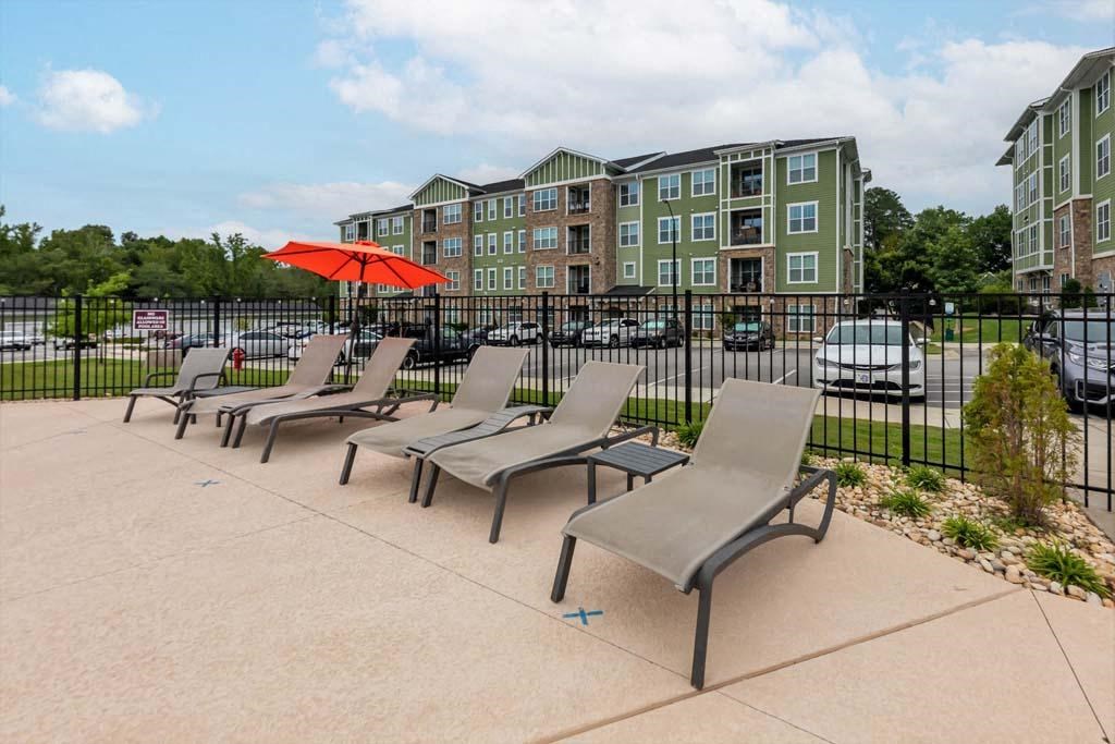 A row of grey chairs are lined up on a concrete area at Foxwood Apartments, Raleigh-Durham, NC, 27616
