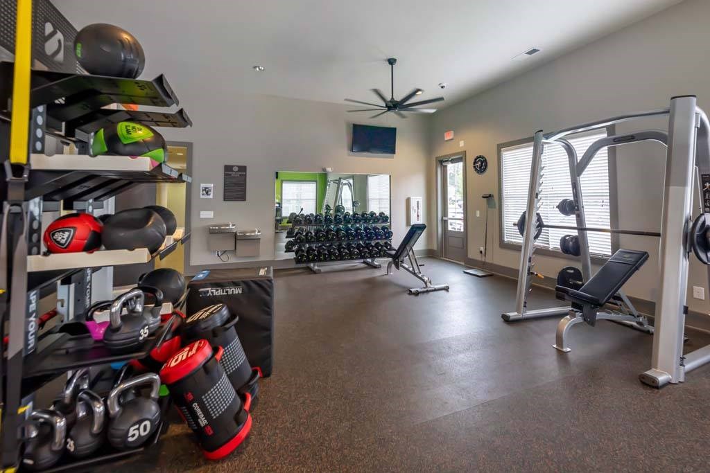 A well-equipped home gym with a variety of exercise equipment at Foxwood Apartments, North Carolina, 27616