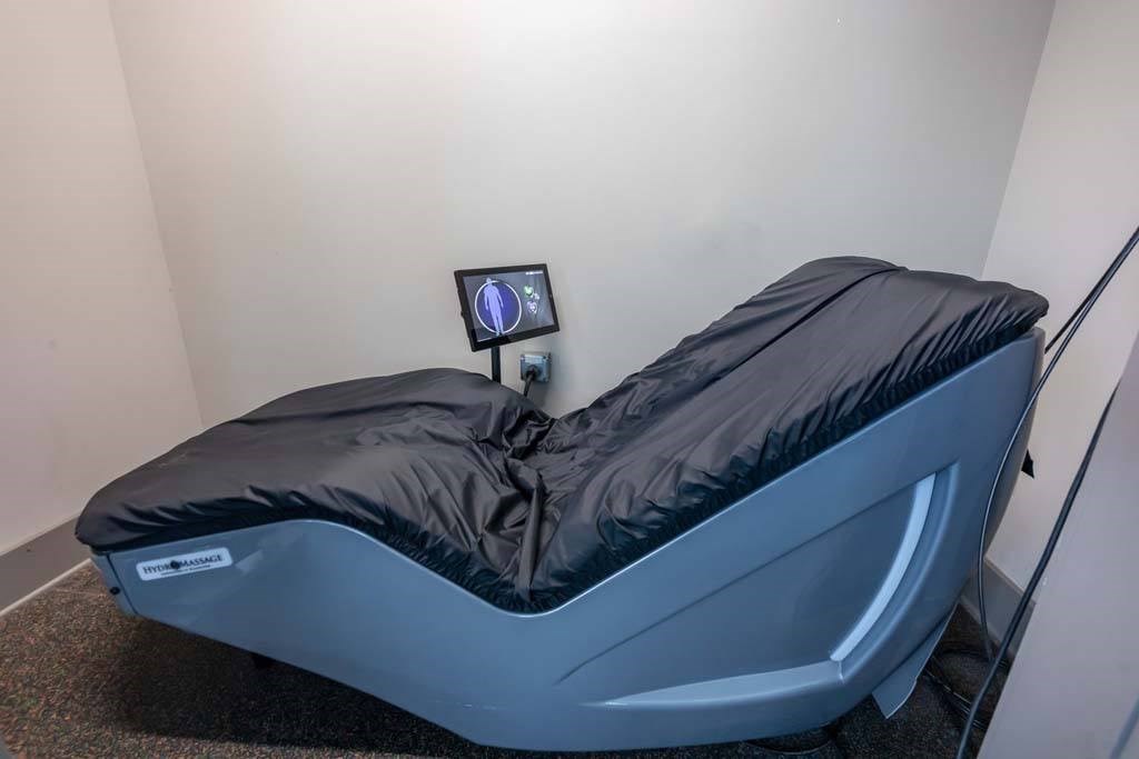 A massage bed with a black cover and a small monitor on top at Foxwood Apartments, Raleigh-Durham, NC