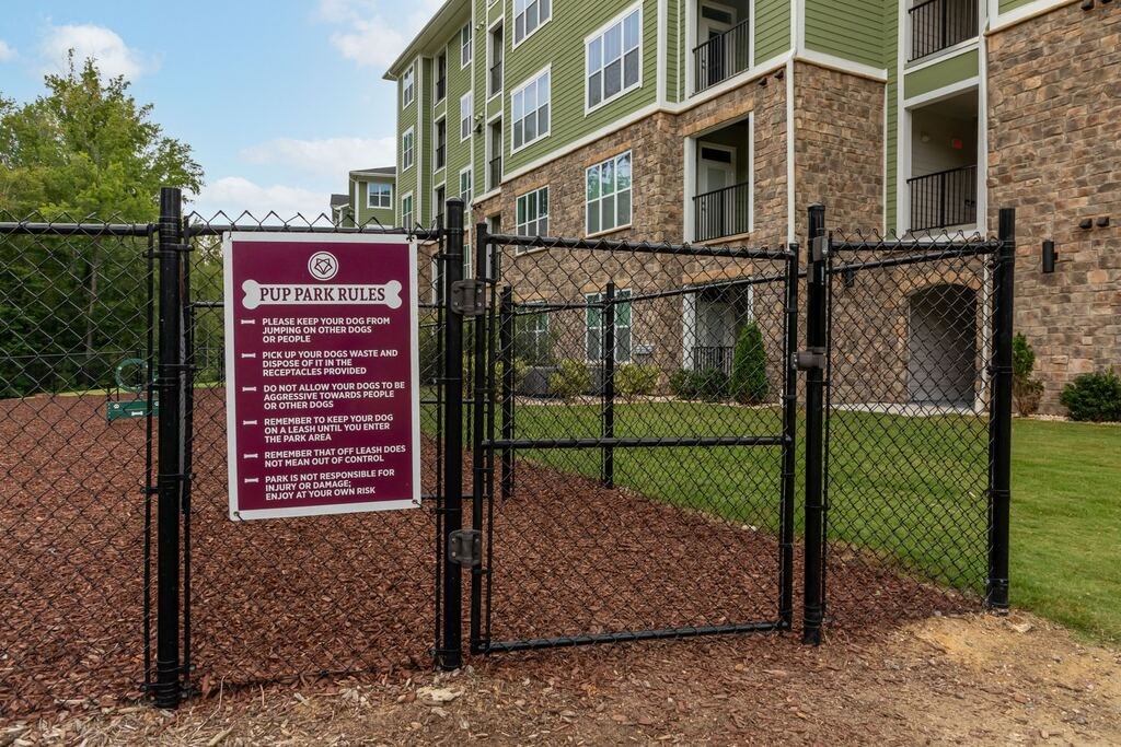 A sign in front of a building that says PUP PARK RULES at Foxwood Apartments, Raleigh-Durham