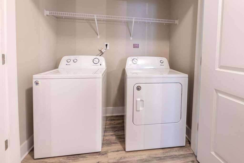 A small laundry room with a washer and dryer at Foxwood Apartments, North Carolina