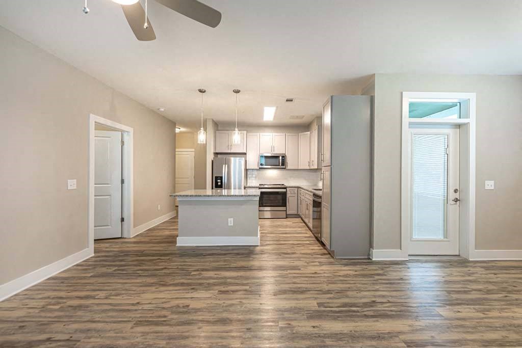 A spacious kitchen with a center island and a fan on the ceiling at Foxwood Apartments, North Carolina, 27616