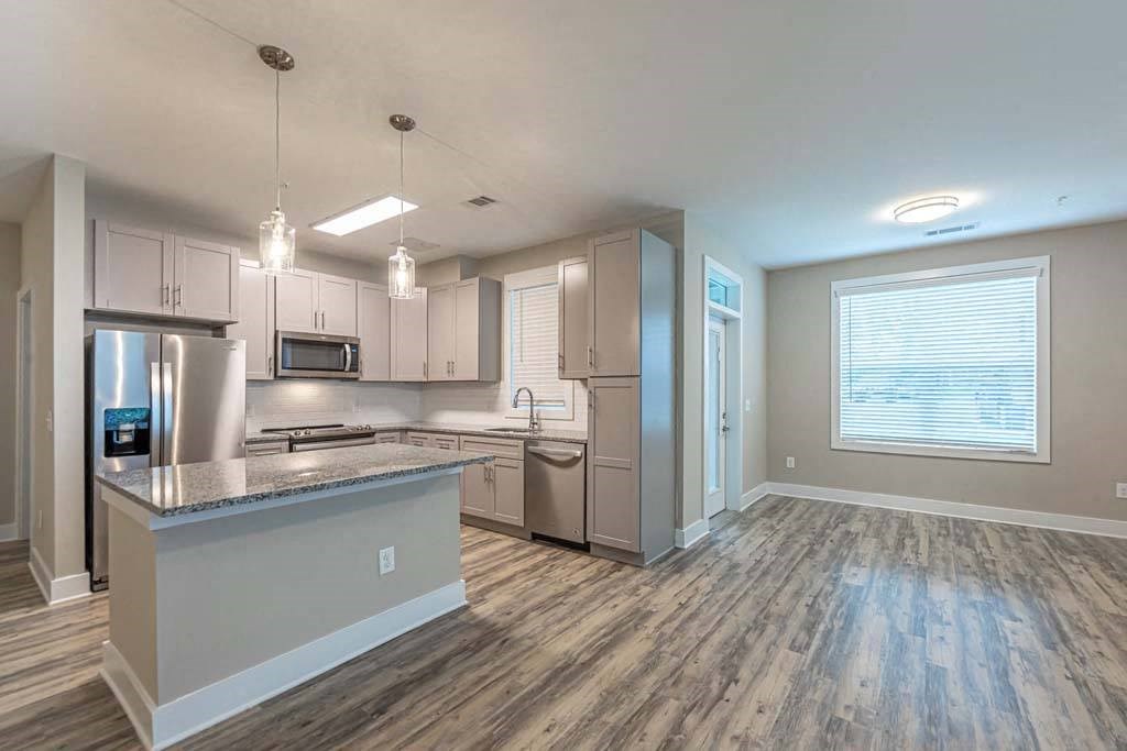 A modern kitchen with a large island and stainless steel appliances at Foxwood Apartments, Raleigh-Durham, 27616