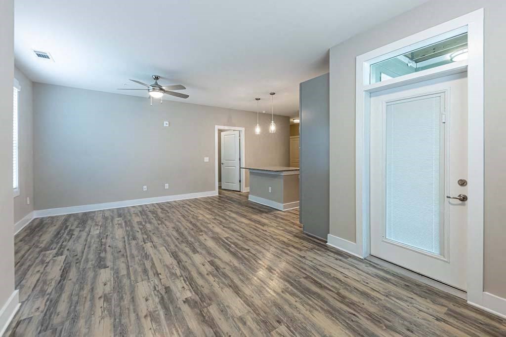 A room with a ceiling fan and wood flooring at Foxwood Apartments, Raleigh-Durham, NC, 27616