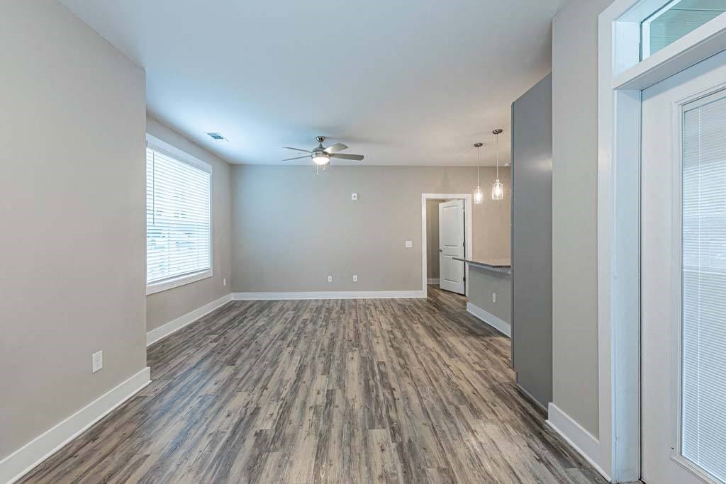 A room with a ceiling fan and wood flooring at Foxwood Apartments, Raleigh-Durham, NC